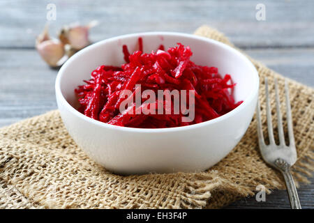 Fresh grated beet in a white bowl, food Stock Photo