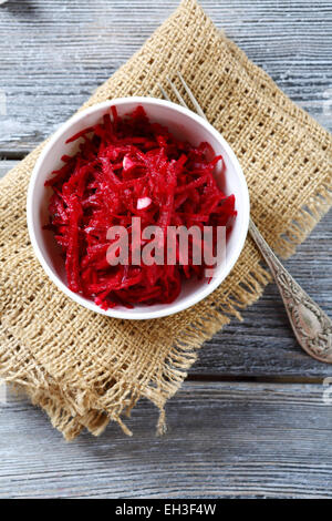 Grated beet red in a bowl on napkin, food Stock Photo