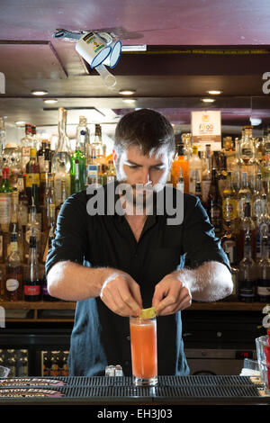 A male barman, bar tender, mixologist makes a fantastic cocktail in a high end restaurant / bar / public house Stock Photo