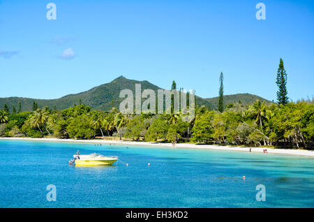 Tropical paradise with soft white sand, perfect blue sea and forest covered mountain. Stock Photo