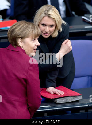 Berlin, Germany. 06th Mar, 2015. German chancellor Angela Merkel (CDU, L) and German Minister of Family Affairs, Senior Citizens, Women and Youth Manuela Schwesig (SPD) talk during a session of parliament in Berlin, Germany, 06 March 2015. The parliament approved a bill to introduce a 30 percent quota for women on supervisory boards. Photo: Soeren Stache/dpa/Alamy Live News Stock Photo