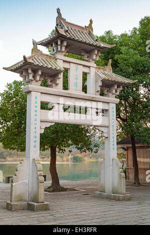 Hangzhou, China - December 5, 2014: Old traditional chinese stone gate on the coast of West lake, famous park in Hangzhou city c Stock Photo