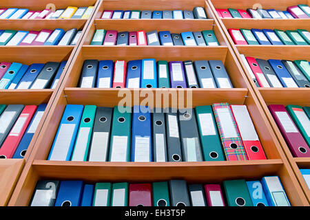 file folders, standing on the shelves in the background Stock Photo