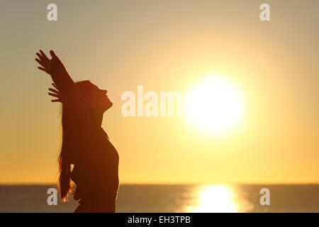 woman-breathing-fresh-air-at-sunset-on-t