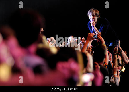 BARCELONA - MAY 23: Thomas Mars, frontman of Phoenix band, singing surrounded by the audience. Stock Photo