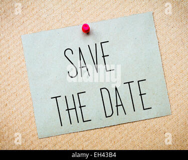 Recycled paper note pinned on cork board.Save the Date Message. Wedding Concept Image Stock Photo