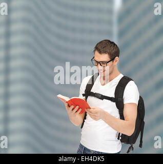 student in eyeglasses with backpack and book Stock Photo