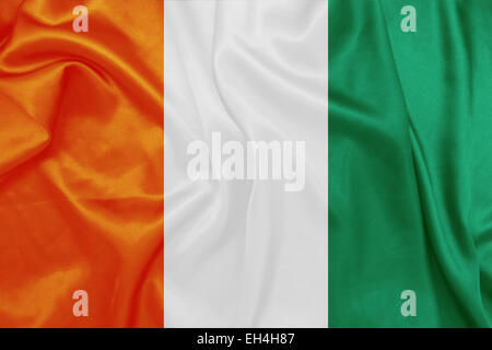 Ivory Coast - Waving national flag on silk texture Stock Photo