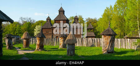 Landscape panorama with a wooden Church and hives.Ukraine,Kiev,Museum of wooden architecture Pirogovo Stock Photo
