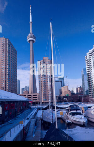 Toronto;Capital City of Ontario;Canada in the winter of 2015; Harbor with ice and snow and boats and CN tower Stock Photo