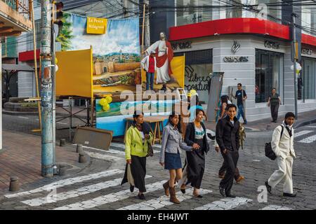 Ecuador, Imbabura, Atuntaqui, street scene of people passing in the street during the preparations for the Easter party on stormy sky at sunset Stock Photo