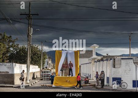 Ecuador, Imbabura, Atuntaqui, street scene of the preparations for the Easter party on stormy sky at sunset Stock Photo