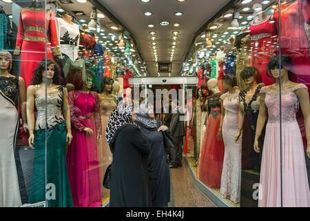 Turkey, Istanbul, Mercan, Turkish women contemplating the window of a traditional dress shop Stock Photo
