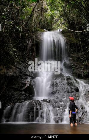 Indonesia, West Sumatra, Minangkabau Highlands, Bukittinggi area, Harau valley, woman near a waterfall in the forest