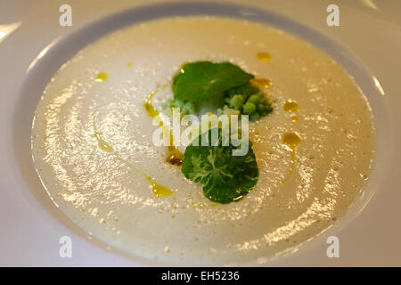 Cauliflower soup with romanesco florets and nasturtium. Stock Photo