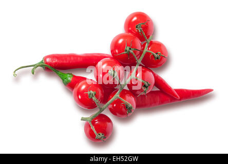 Branch of cherry tomatoes and two red chili peppers isolated on white background Stock Photo