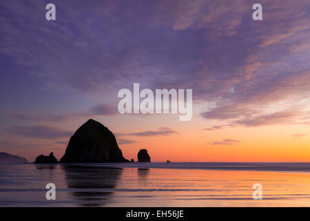 Sunset over Haystack Rock along the Oregon Coast at Cannon Beach, USA Stock Photo