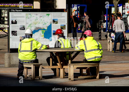 Scottish Muirfield building contractors having a lunch break at the City Square in Dundee, UK Stock Photo