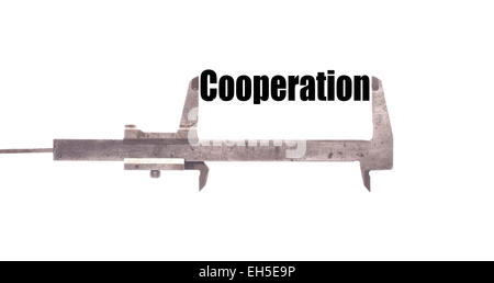 Color horizontal shot of a caliper and measuring the word "cooperation". Stock Photo
