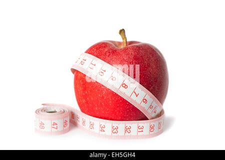 A diet / dieting concept photo. Apple with a measure tape on. Stock Photo