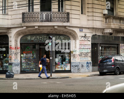 Argentina, Buenos Aires, Almagro, Avenida Rivadiva, pharmacy entrance covered in grafitti Stock Photo