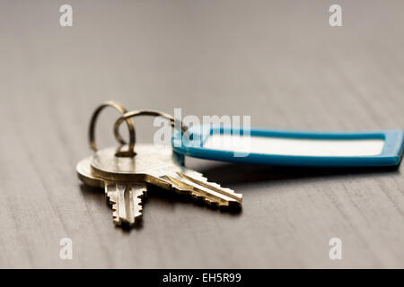 Macro Shot of Conceptual House Keys on Top of Wooden Table Stock Photo