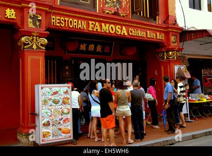 Melaka, Malaysia:  A crowd waiting outside for a table at the famous Famosa Chicken Rice Ball Restaurant on Jonker Walk Stock Photo