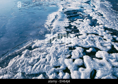 Patterns in ice and snow on the beach beside a frozen Alaskan river. Stock Photo