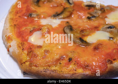 Tipical Italian Pizza with mushrooms cooked in a wood steam Stock Photo