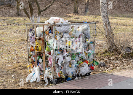 Metallic garbage container full of trash, outdoor in the country Stock Photo
