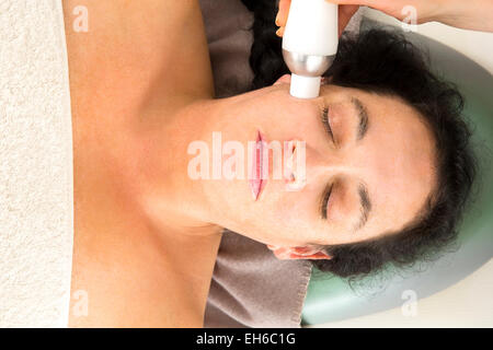 Woman receives diamond peeling at beauty clinic Stock Photo