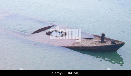 Lonely sinking boat, in the turcose sea Stock Photo