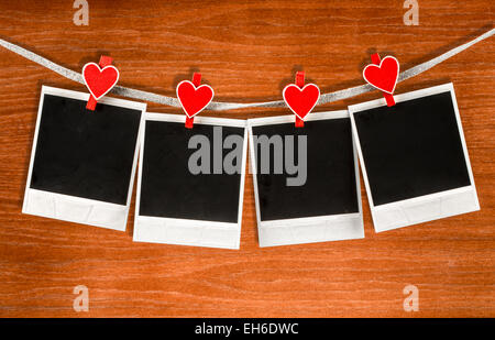 Old photo frames on wood background. Valentines message. Stock Photo