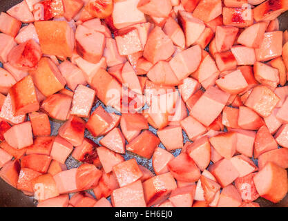 A lot of fried sausage dice, on a frying pan Stock Photo