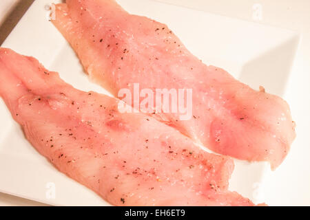 Raw white zander fillets, on a white plate Stock Photo