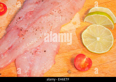 Light zander fillets, near lime and cherry tomatoes Stock Photo