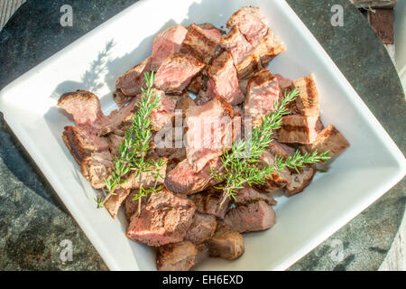 Diced moose meat and thyme, in a porslin bowl Stock Photo