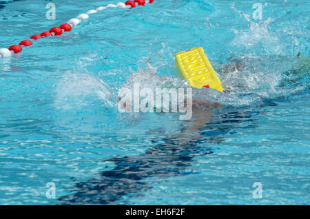 Pool training with yellow rescue buoy Stock Photo