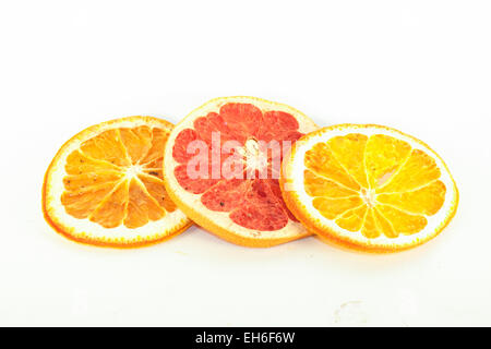 Dry orange and grape fruit slices, on isolated white background Stock Photo