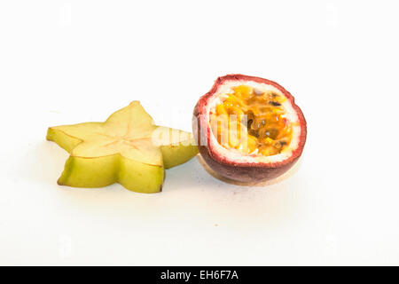 A green carambola and a colorful  passion fruit, on white background Stock Photo