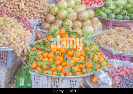 A pile of orange mandarins, at a market Stock Photo