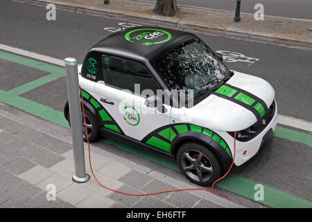 A Zen Car (car sharing) electric car plugged in to a road side power source in Brussels, Belgium. Stock Photo