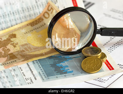 Price index graph magnifying glass and euro currency Stock Photo