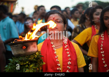 Woman hindu pilgrim with fire kavaldi walking to Batu Cave temple, Kuala Lumpur Malaysia during Thaipusam 3rd FEB 2015 Stock Photo