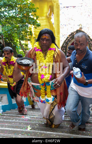 Hindu pilgrim climbing Batu Cave temple staircase, Kuala Lumpur Malaysia during Thaipusam festival on 3rd  FEB 2015. Stock Photo