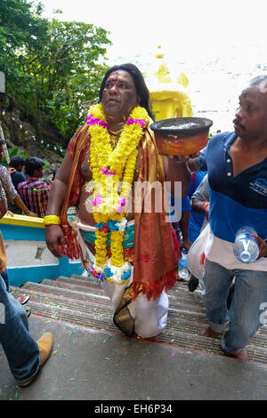 Hindu pilgrim climbing Batu Cave temple staircase, Kuala Lumpur Malaysia during Thaipusam festival on 3rd  FEB 2015. Stock Photo