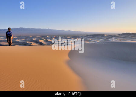 Khongoryn Els Sand Dunes At Sunset With Lady and Horizon, Gobi Desert Stock Photo