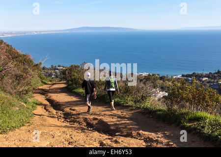 Hikers on  fire road in Topanga State Park that can be accessed via the Los Leones Trail in Pacific Palisades Stock Photo