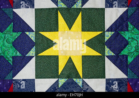 hand made quilt detail with colorful patterned cloth Stock Photo