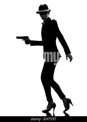 one stylish  woman in suit holding gun in silhouette on white background Stock Photo